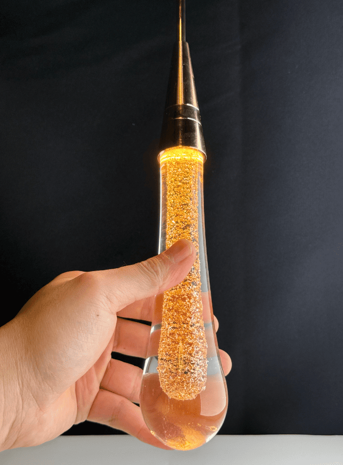 Large crystal raindrop chandelier, champagne rain with gold powder for luxury dining room foyer high ceiling,
Close-up of a crystal