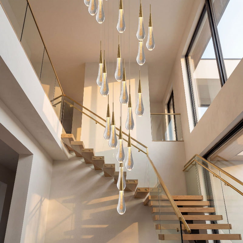 Elegant Champagne Rain crystal raindrop chandelier with gold powder creating waterfall lighting effect in modern residential staircase entryway