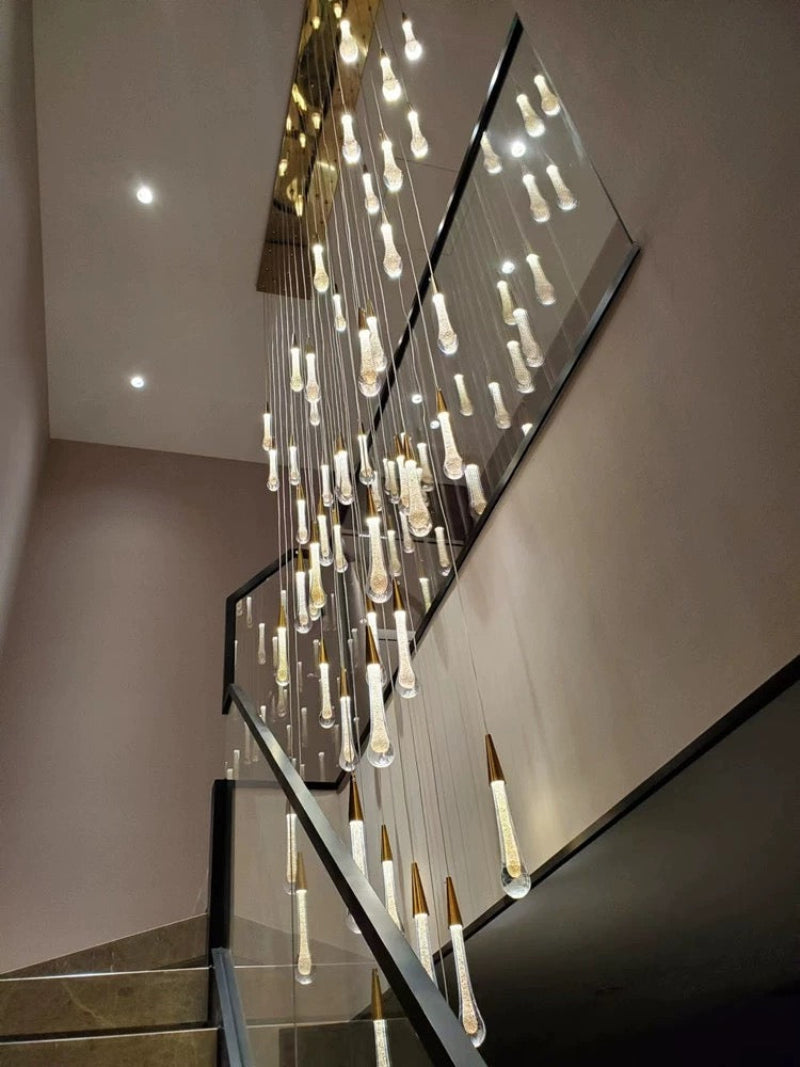 Stylish crystal raindrop chandelier with champagne-colored Champagne Rain and gold powder accents providing brilliant lighting for small stairwell