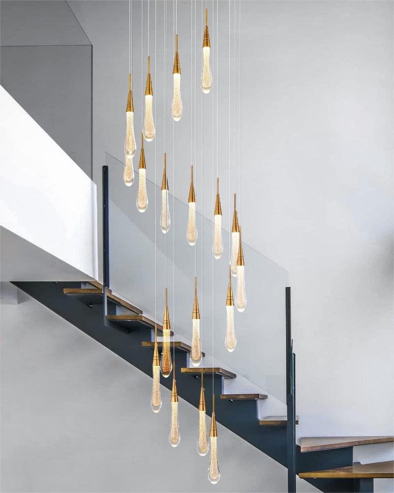 Crystal raindrop chandelier featuring Champagne Rain elevating staircase foyer entryway with chic design and gold glow effect