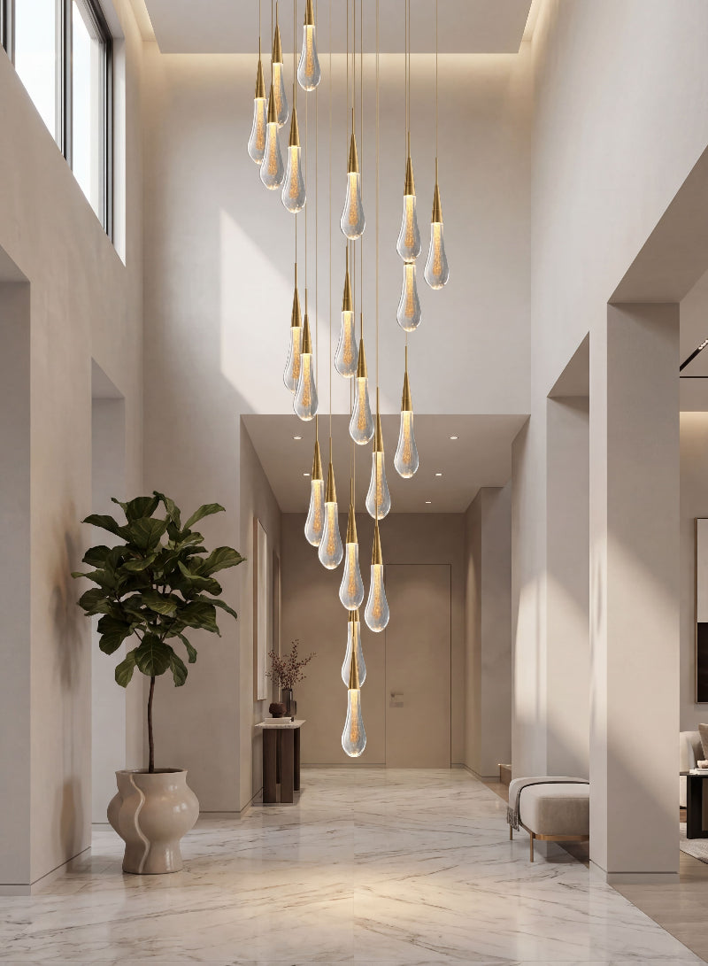 Designer Champagne Rain crystal raindrop chandelier with spiral arrangement creating dramatic lighting installation in contemporary stairwell void