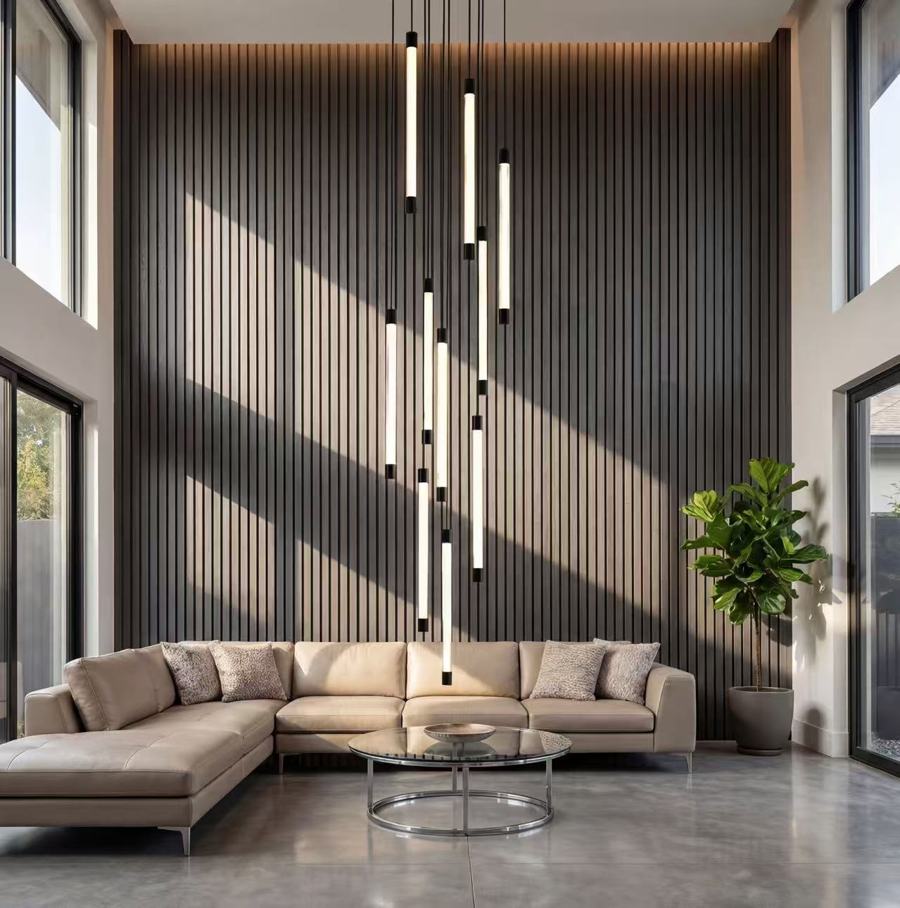 Elegant tubular acrylic cascade chandelier with brass accents creating waterfall light sculpture in luxury staircase foyer two-story ceiling