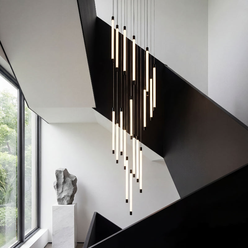 Luminous cascade modern chandelier with tubular acrylic creating brilliant waterfall effect in luxury residential staircase foyer entryway