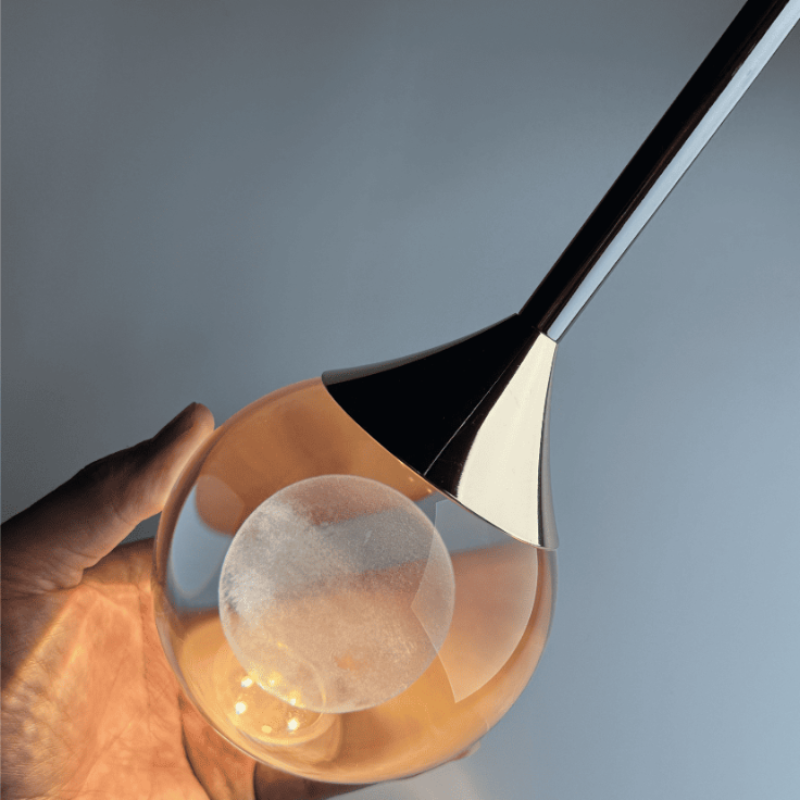 Modern luxury mosaic crystal chandelier, laser-engraved moon spheres for living room foyer staircase high ceiling,close-up of a crystal