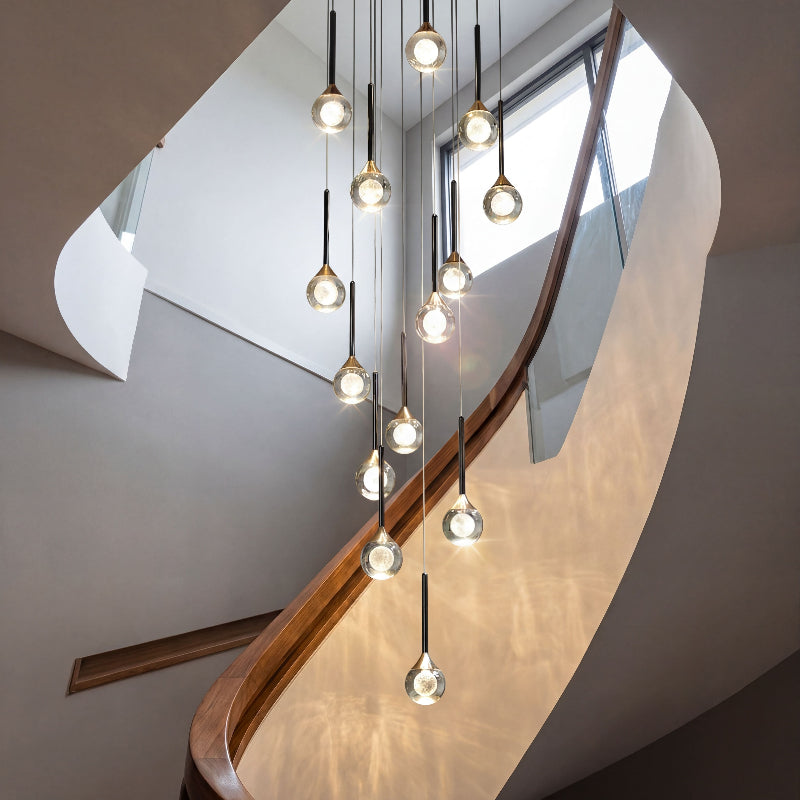 Designer Gemstone Cascade mosaic crystal chandelier with laser-engraved moon design creating dramatic lighting in contemporary stairwell void