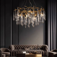 Thumbnail for A luxurious Gilded Copper Icicle Chandelier with handcrafted copper elements and crystal pendents, hanging over a sofa in a dimly lit room, showcasing its elegant design.