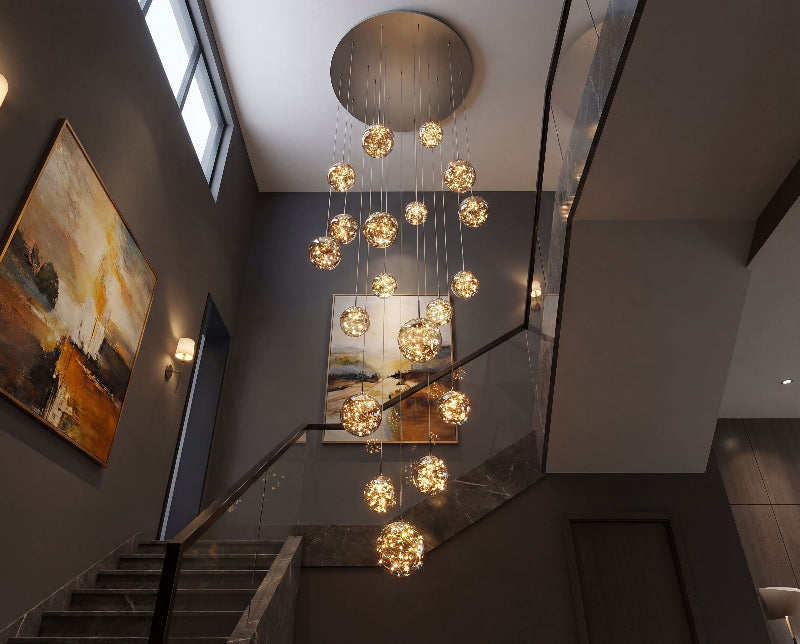 Artistic firefly-inspired chandelier with adjustable glass spheres creating elegant ambient lighting in luxury residential foyer