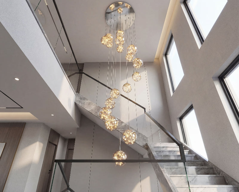 Designer modern art chandelier with firefly-inspired glass bubbles creating dramatic lighting in contemporary stairwell void