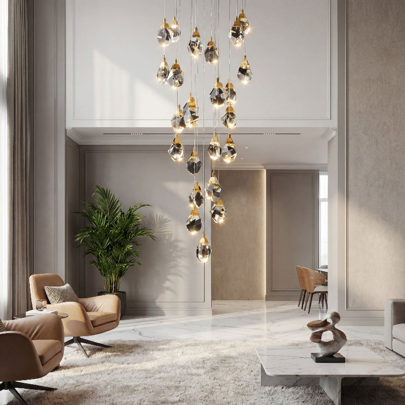 Artistic irregular raw-cut crystal geode pendant with natural brass creating brilliant light refraction in contemporary high ceiling space