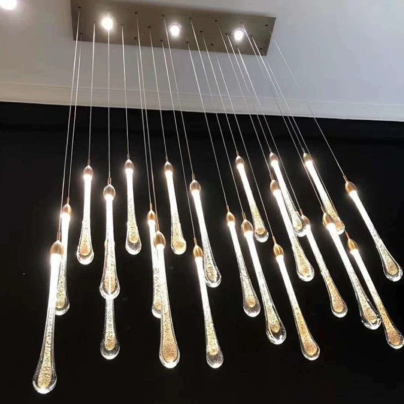 A chandelier with multiple hanging lamps, against a dark background, suitable for a dining room.