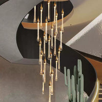 Thumbnail for A luxurious golden chandelier with tear-shaped crystal drops suspended in a staircase setting, highlighting a warm and elegant lighting ambiance.