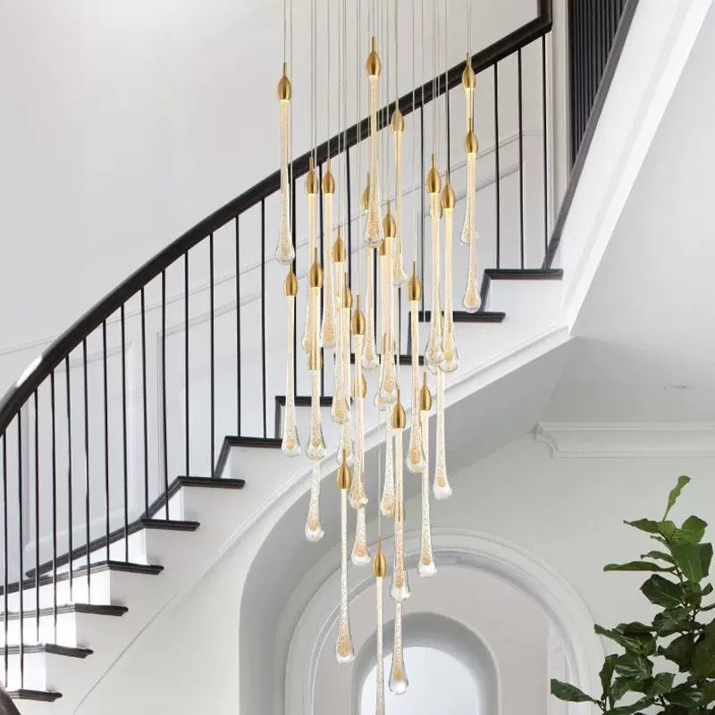 Gold angel tears crystal chandelier, cascading teardrop design elevating staircase foyer entryway ambiance with flair