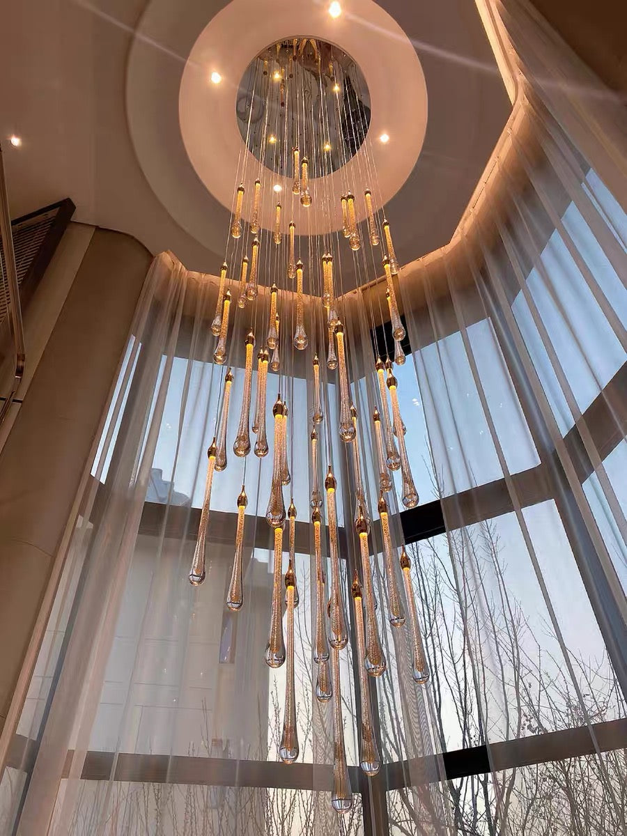 Luxury gold angel tears crystal chandelier, cascading teardrop design transforming staircase foyer high ceiling,warm light effect.