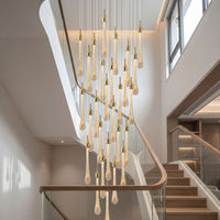 Thumbnail for Modern angel tears chandelier featuring gold finish and cascading crystal teardrops creating dramatic lighting effect in high-ceiling entryway