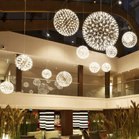 Thumbnail for This modern LED firework chandelier for lobbies features a chrome-plated starburst dandelion design, suitable for large spaces with high ceilings such as commercial shopping malls.