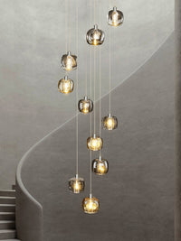 Thumbnail for A modern staircase square crystal chandelier with brass fittings hanging in a luxurious interior space, highlighting its elegant design and contemporary style.