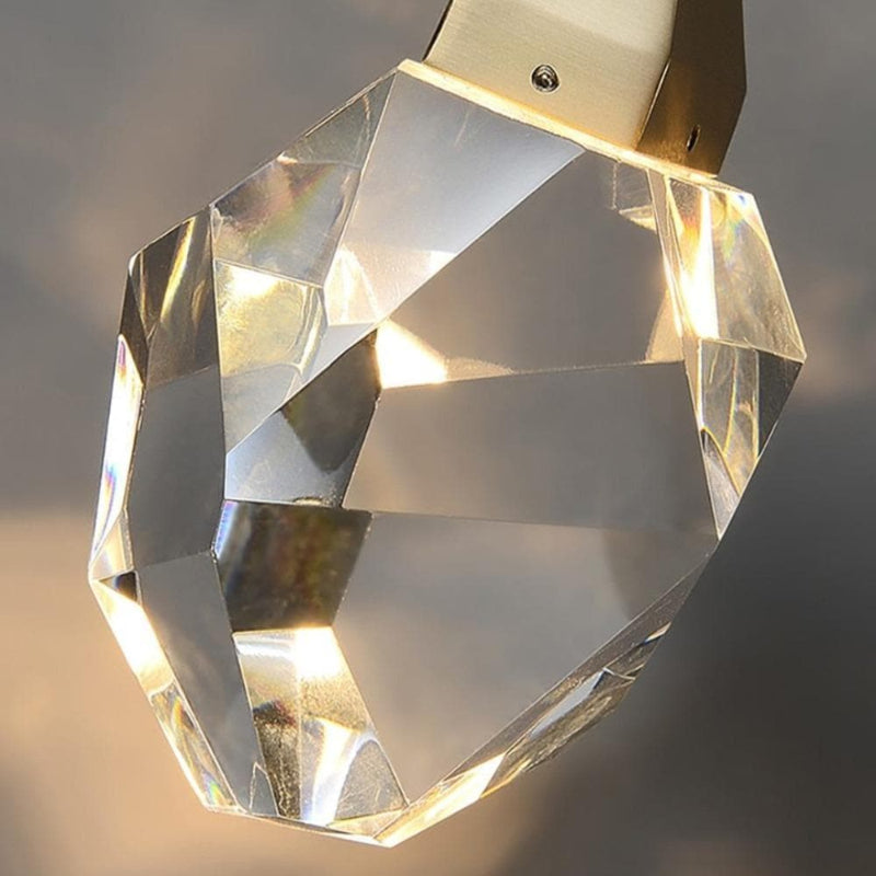 Close-up irregular raw-cut K9 crystal prism, natural brass chandelier with light refraction design