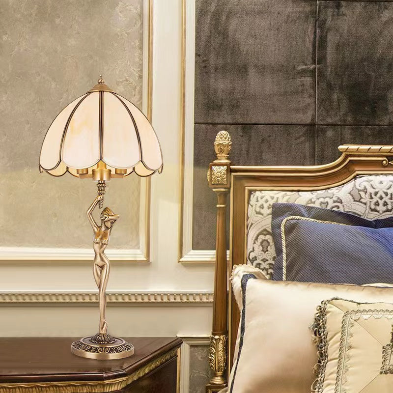 Golden art table lamp detail, all-copper handcrafted sculptural design with glass shade for bedroom living room