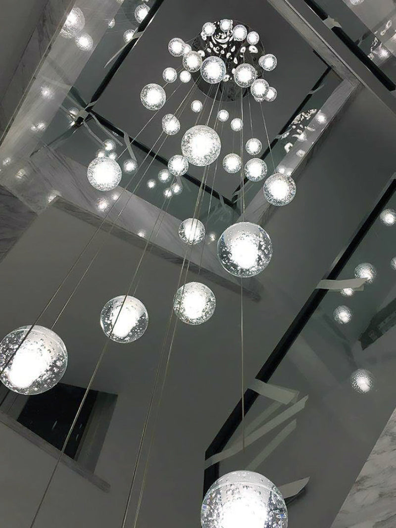 Warm white dimmable LED crystal ball pendant viewed from below with random sphere arrangement for stairwell two-story high ceiling