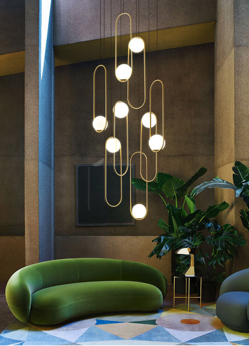 Modern gold 8-light glass globe chandelier with random hanging design and warm white light for foyer entryway staircase