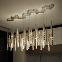 Thumbnail for A round, silver, linear cylindrical pendant light with a modern meteor shower design, featuring perforated tubes, suitable for restaurant lighting.