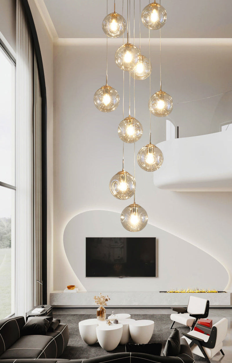 Three-dimensional bubble chandelier with light yellow Murano-style glass creating cozy warm glow for staircase foyer entryway