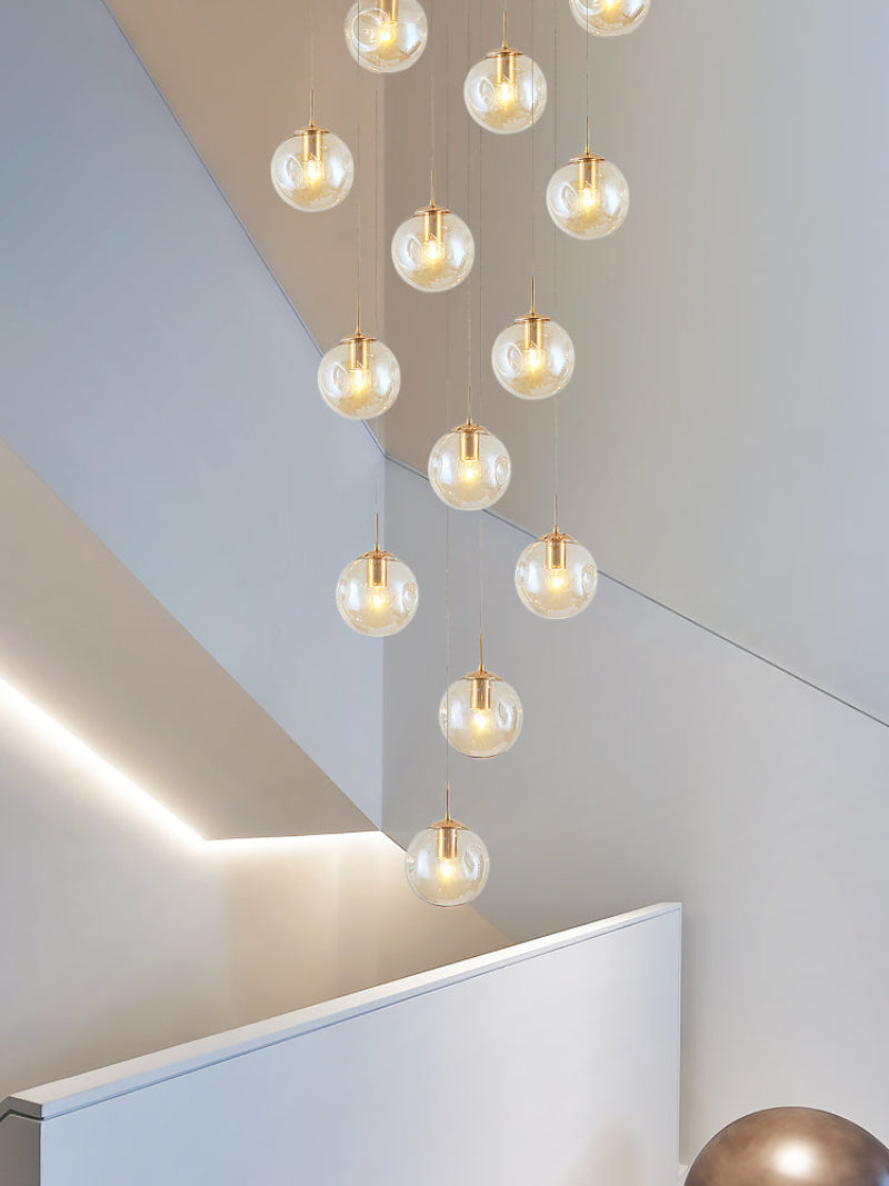 Pendant chandelier with handcrafted textured bubble spheres creating visual depth for entryway foyer high ceiling installation
