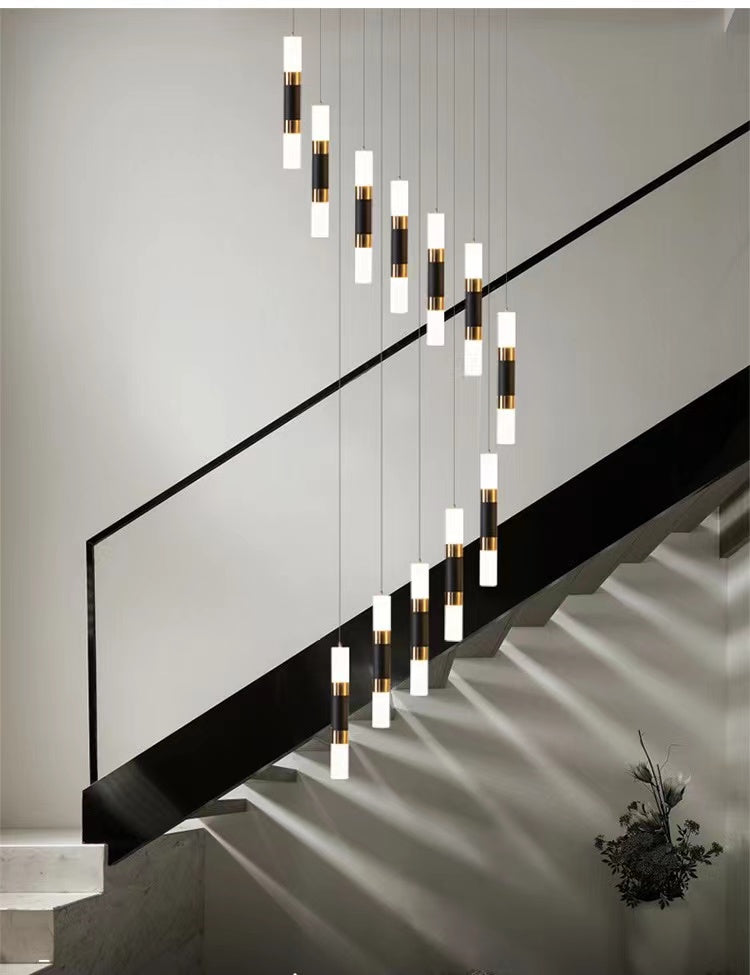 Spiral crystal chandelier lights with staircase design creating elegant lighting for foyer entryway two-story space