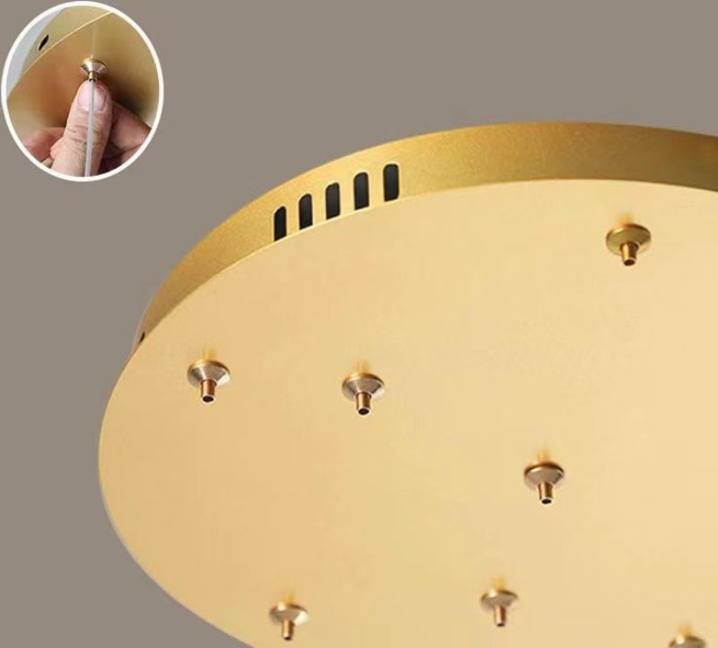 Gold ceiling light fixture with detailed design on a gray background
