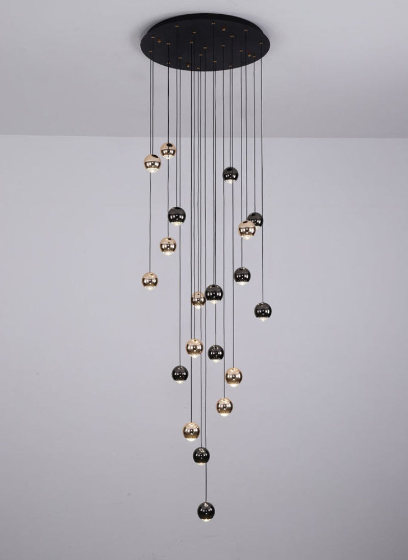 Black crystal fixture with cognac glass bronze truffle spheres creating contemporary elegance for foyer staircase entryway