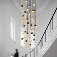 Thumbnail for A modern chandelier with a bi-material design, featuring aircraft-grade aluminum and precision-cut K9 crystal, structured in a ball shape with multiple lights, installed in a interior space.