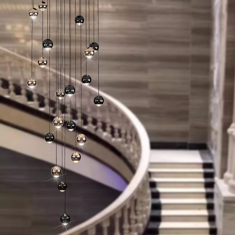 Luxurious bronze truffle chandelier with cognac glass orbs creating sophisticated glow for staircase foyer high ceiling