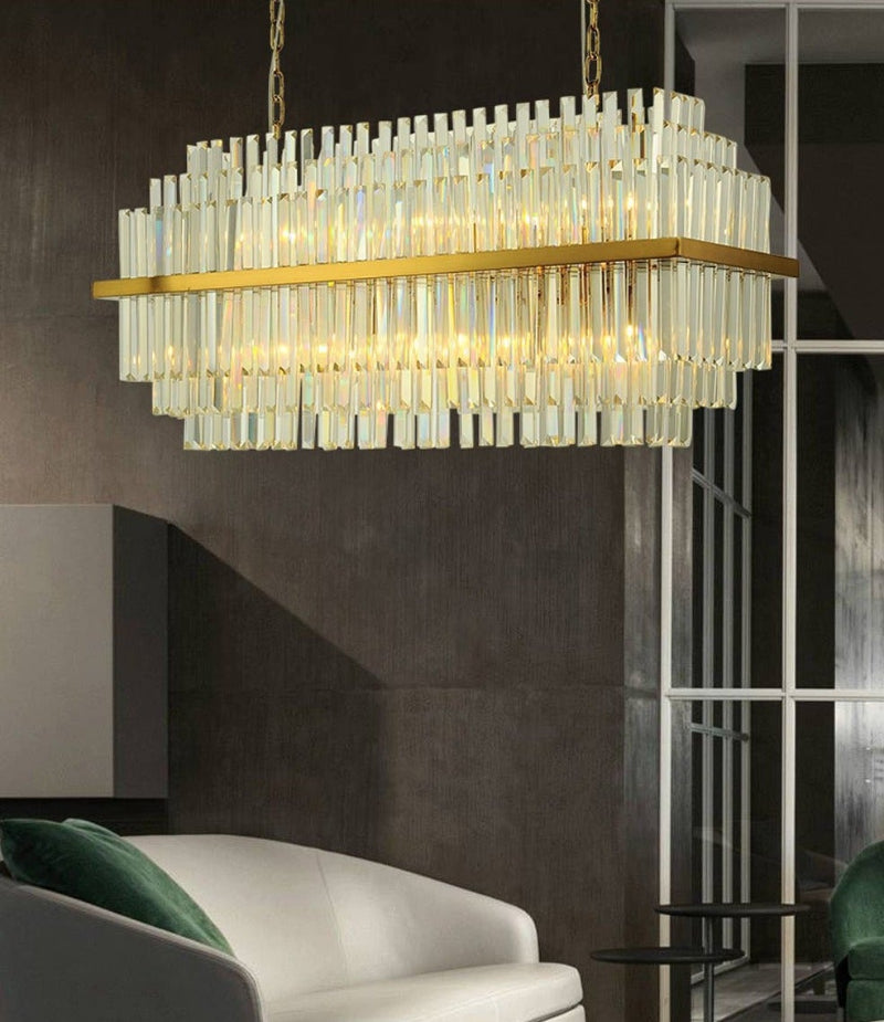 Modern gold chandelier with brushed steel and tiered crystals creating statement piece for grand dining room reception hall