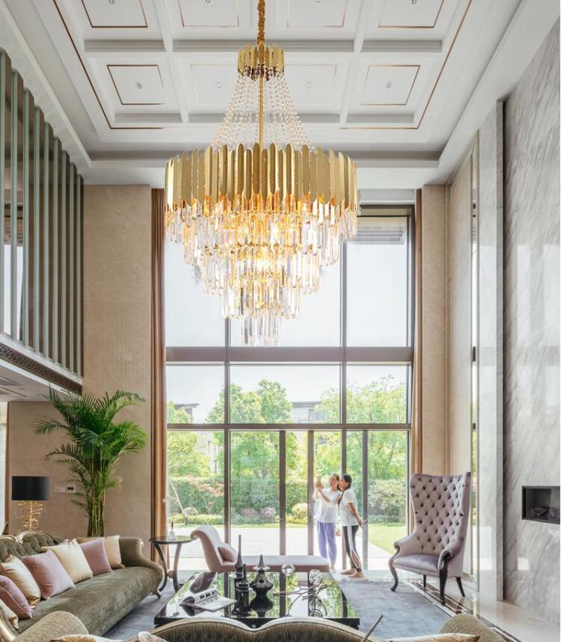 Luxury K9 crystal chandelier with starburst design creating soft ambient lighting for grand living room hotel lobby staircase