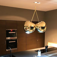 Thumbnail for Modern gold-colored chandelier with a rectangular canopy, hanging in a room with brown wooden ceiling and walls.