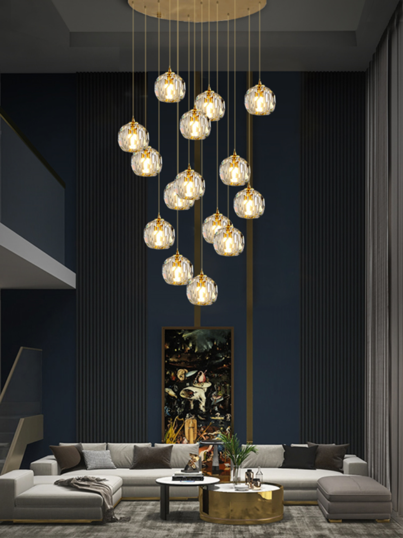 Multi-faceted crystal ball chandelier with linear design creating dazzling star-like rays for modern staircase foyer entryway