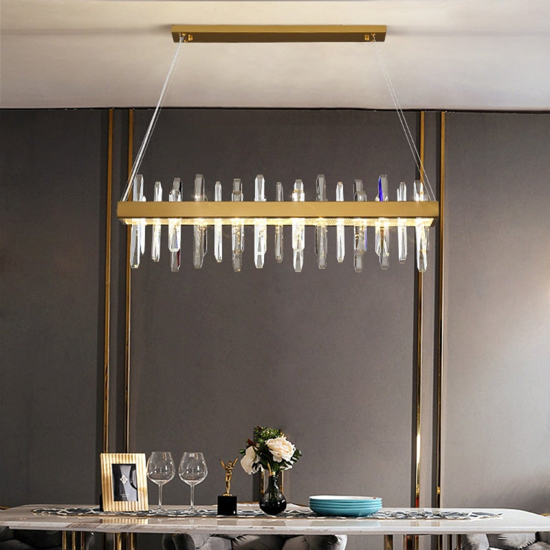 Brushed gold crystal chandelier with linear Crystal Bar design creating elegant ambiance for dining room kitchen island modern space