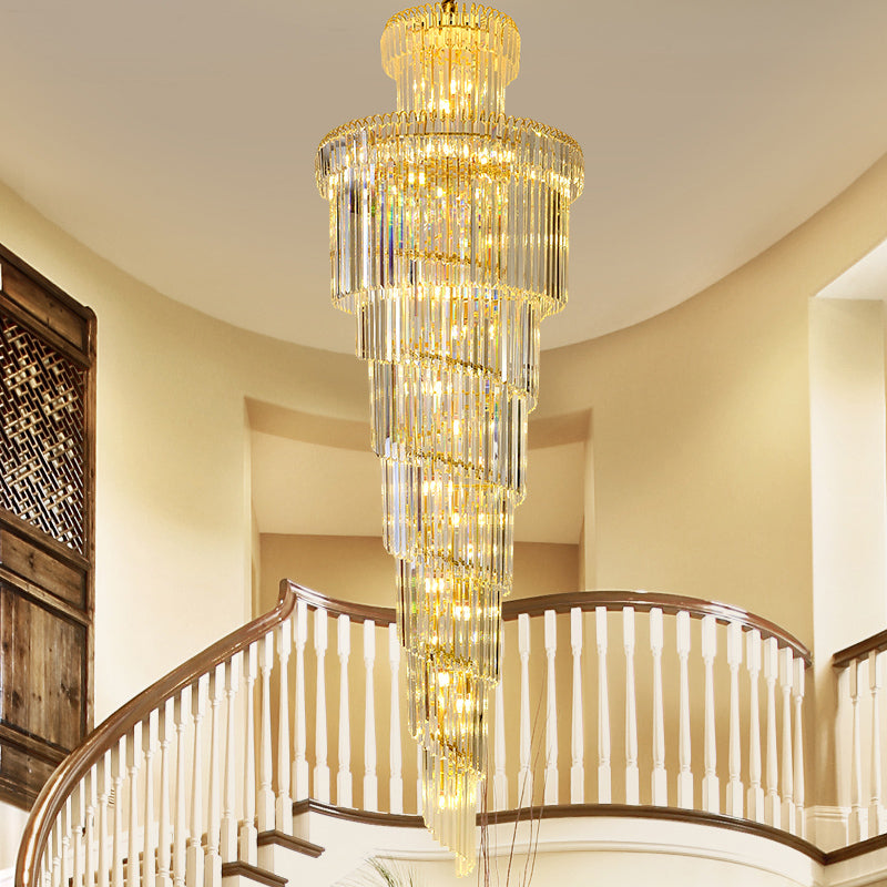 High-end circular crystal chandelier with spiral design creating luxurious focal point for double-height foyer hotel lobby