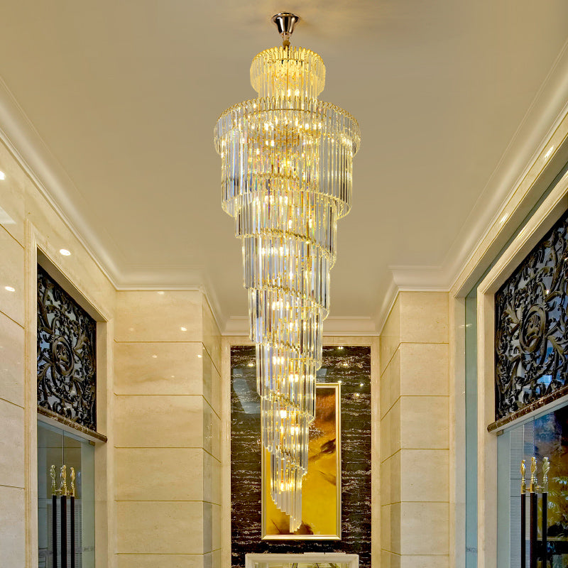 Circular K9 crystal chandelier with spiral cascade creating sculptural centerpiece for grand foyer staircase double-height void