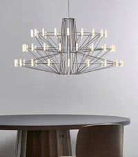 Thumbnail for Modern chandelier hanging above a round table with a neutral background