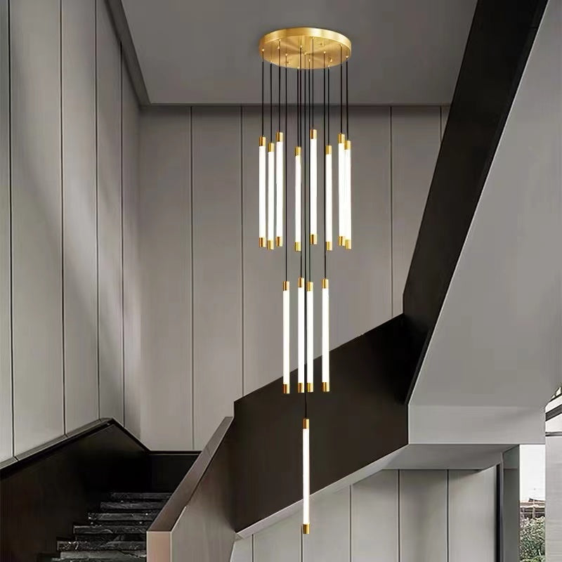 Natural brass cascade chandelier with elongated tubular acrylic creating warm organic elegance for staircase foyer entryway