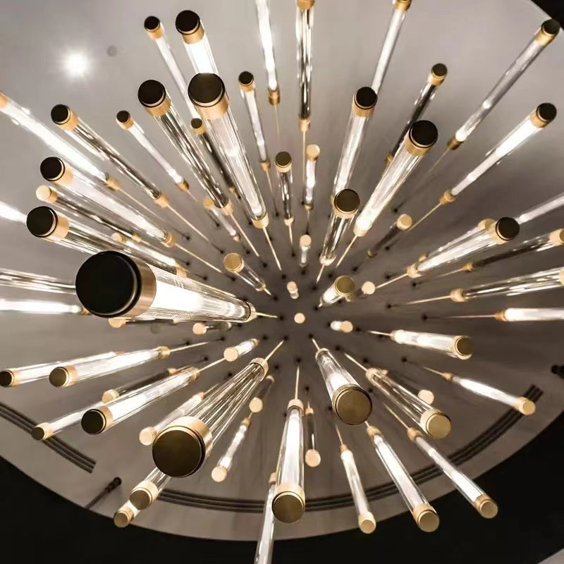 Brass and acrylic cascade chandelier with elongated tubular design creating flowing light for staircase foyer high ceiling