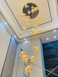 Thumbnail for Round glass bubble chandelier with adjustable wires creating firefly-like display for staircase foyer entryway cathedral ceiling