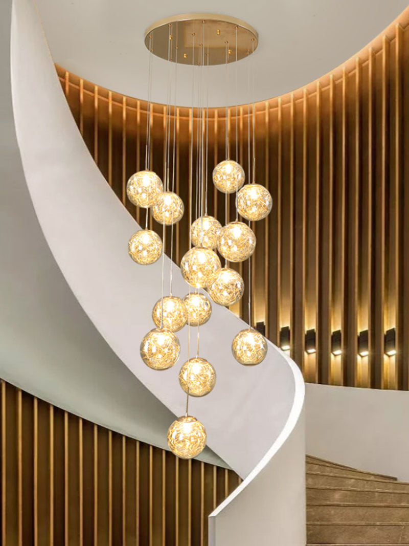 Round modern bubble chandelier with firefly-inspired arrangement creating dynamic light for staircase foyer entryway two-story ceiling