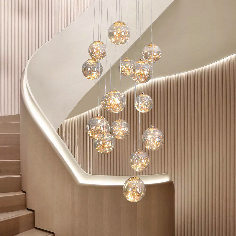 Glass bubble light fixture with firefly-inspired design creating poetic experience for modern staircase foyer entryway high ceiling