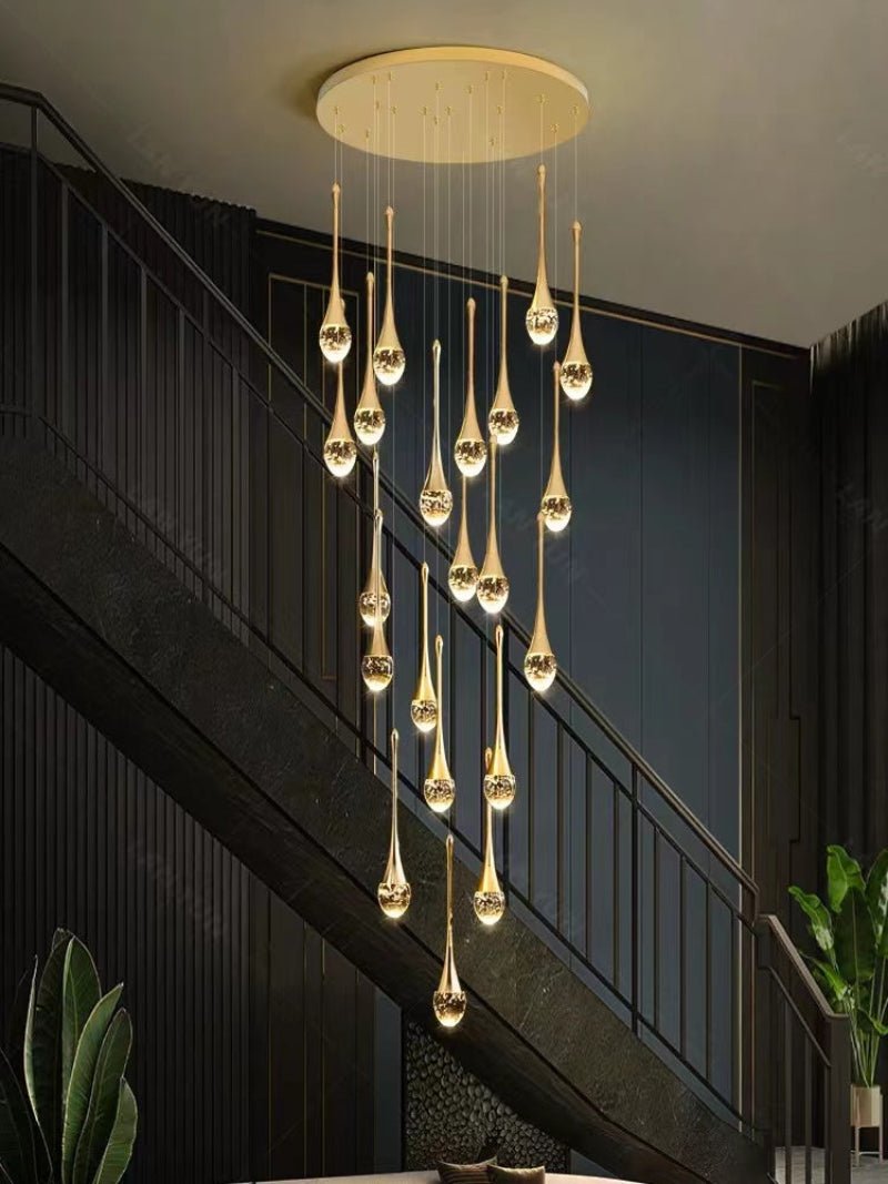 Round gold crystal teardrop chandelier featuring Golden Tears solid crystal with bubble effects in random permutation for foyer staircase entryway