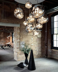 Thumbnail for Modern chandelier hanging in a stylish room with brick walls and industrial decor.