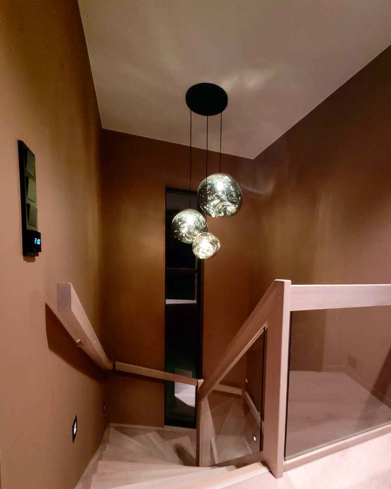 Staircase with modern pendant lights in a home interior setting
