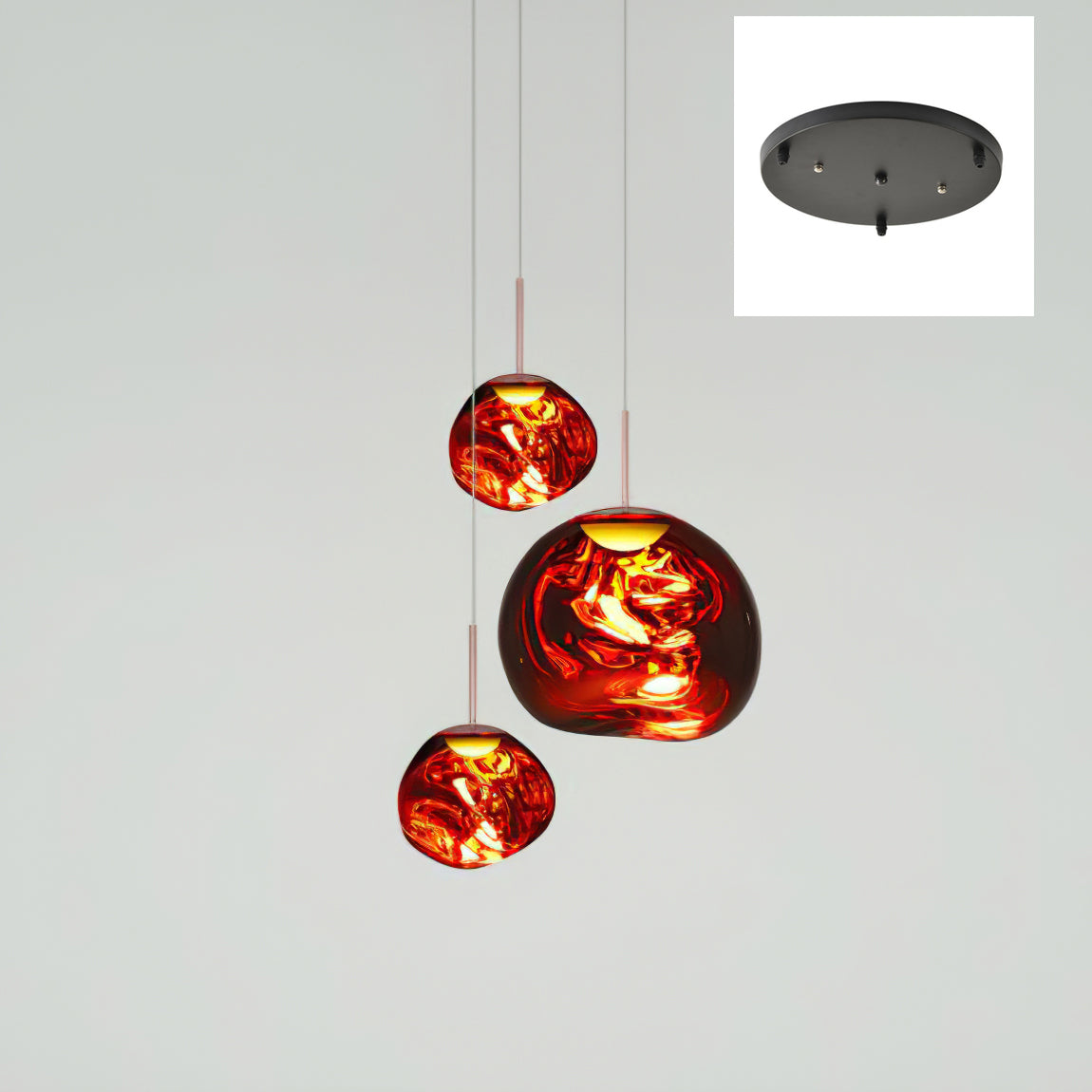 A group of spherical lighting fixtures with a metallic finish suspended from a ceiling canopy, designed to provide ambient lighting.