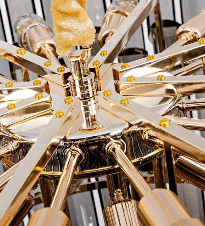 Mono Brenton chandelier with smoky grey and clear K9 crystals creating elegant ambiance for modern living room dining room